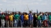 Mine workers protest outside the Lonmin mine in Rustenburg, northwest of Johannesburg, Jan. 23, 2014. 