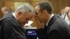 Oscar Pistorius talks with attorney Barry Roux, left, on the second day of trial, Pretoria, March 4, 2014.