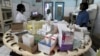 Nurses work in the pharmacy at the general hospital in Man, western Ivory Coast, July 4, 2013. 