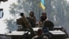 Ukrainian soldiers look out from a tank at a position some 60 km from the eastern Ukrainian city of Donetsk, July 10, 2014.