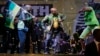 The ruling party president Jacob Zuma, center, sings and dances, at a victory party downtown Johannesburg, South Africa, following the announcement of the results for the 2014 national election result Saturday May 10, 2014