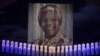 Candles are lit under a portrait of former South African President Nelson Mandela in his ancestral village of Qunu December 15, 2013.