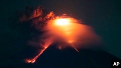 Lava cascades down the slopes of Mayon volcano as seen from Legazpi city, Albay province, around 340 kilometers (210 miles) southeast of Manila, Philippines, Monday, Jan. 15, 2018. 
