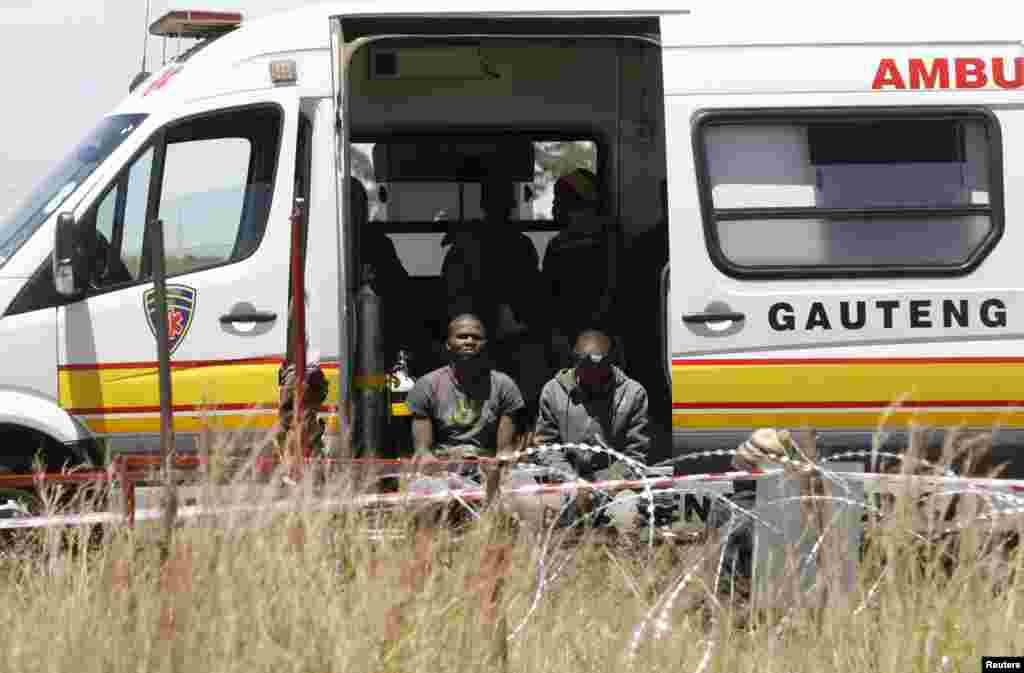 Suspected illegal miners await treatment after emerging from an abandoned gold shaft in Benoni, east of Johannesburg, South Africa, Feb. 17, 2014.&nbsp;