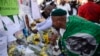 A man views tributes and flowers outside the Medi-Clinic Heart Hospital where ailing former South African President Nelson Mandela is being treated, in Pretoria, July 2, 2013.