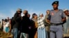 File - A police officer looks on at a voting station during the Lesotho national election in Magkhoakhoeng village outside the capital Maseru, Feb. 28, 2015. 