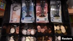 A shop cash register is seen with both sterling and euro currency in the till at the border town of Pettigo, Ireland, Oct. 14, 2016. 