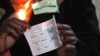 An electoral officer shows a ballot for House of Assembly candidates as the country went to the polls in a Harare suburb, July 31 2013. 