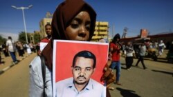 Una mujer sudanesa lleva un retrato del maestro Ahmed al-Khair mientras celebra después de la sentencia de muerte de 29 miembros del servicio nacional de inteligencia al colgarse por el asesinato de un maestro detenido en febrero durante las protestas. Foto: REUTERS.