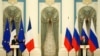 Russian President Vladimir Putin, right, listens during a joint press conference with French President Emmanuel Macron after their talks Monday, Feb. 7, 2022 in Moscow.