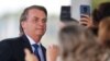 El presidente de Brasil posa para fotos de seguidores al salir del Palacio de la Alvorada en Brasilia, el 12 de diciembre de 2019. Foto REUTERS/Adriano Machado.
